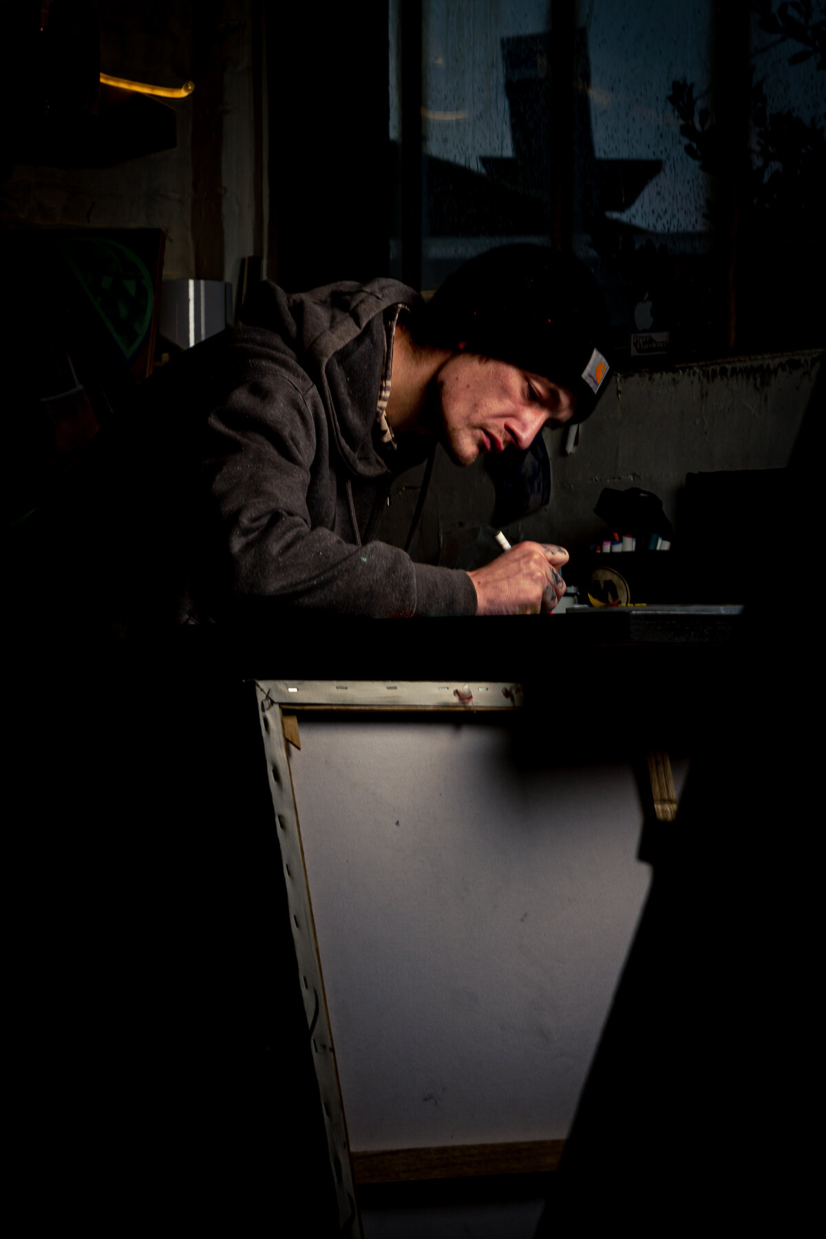 Reportage atelier, artiste au travail dans la pénombre par Luca Struglia